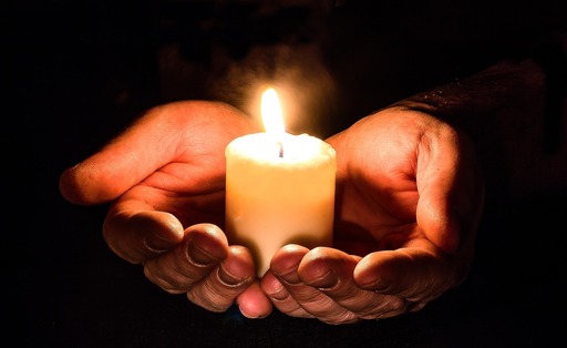 hands holding candle.jpg